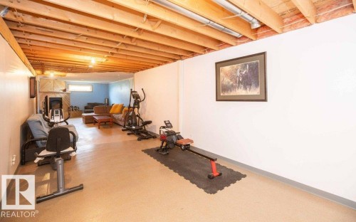 Expansive lower level featuring an exposed wood joist ceiling, light-toned flooring, and painted perimeter walls - 57532 Rg Rd 270, Rural Westlock County, AB 
