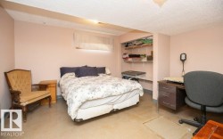 Room featuring neutral wall tones, textured ceiling, and built-in shelving - 