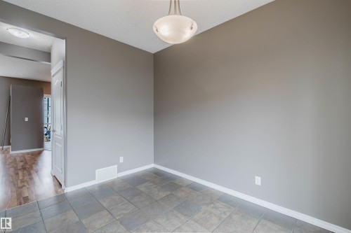 Room featuring gray tile flooring, neutral wall paint, and white baseboards - 38 1780 Glastonbury Boulevard, Edmonton, AB 