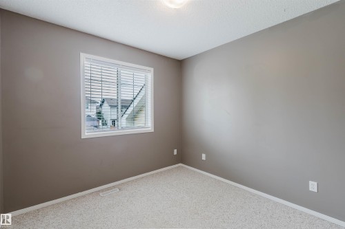Room featuring neutral-toned walls, light-colored carpeting, and a single window with horizontal blinds - 38 1780 Glastonbury Boulevard, Edmonton, AB 