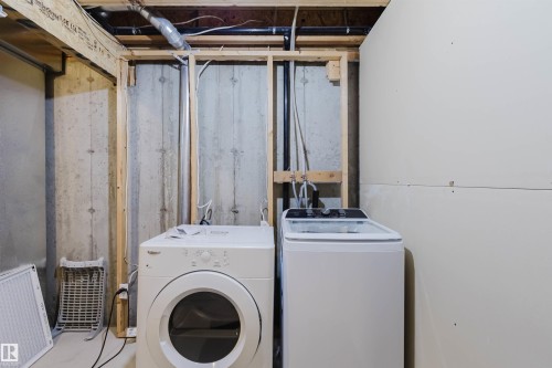 Utility area featuring exposed concrete walls and overhead piping - 38 1780 Glastonbury Boulevard, Edmonton, AB 