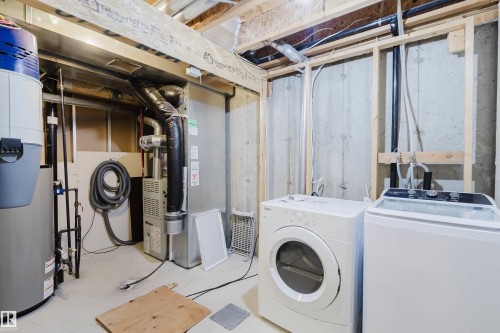 Laundry area featuring a top-loading washing machine and front-loading dryer - 38 1780 Glastonbury Boulevard, Edmonton, AB 