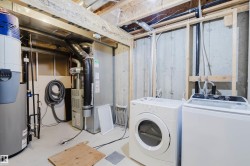 Laundry area featuring a top-loading washing machine and front-loading dryer - 