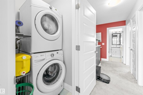 Dedicated laundry closet featuring a stacked washer and dryer - 389 Charlesworth Drive, Edmonton, AB 