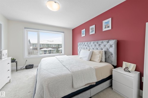 Expansive window providing natural light, complemented by a flush-mount ceiling light fixture - 389 Charlesworth Drive, Edmonton, AB 