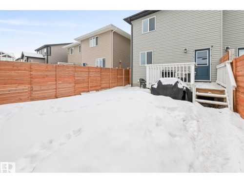 Private backyard featuring wood fencing and a multi-level deck with white railings - 389 Charlesworth Drive, Edmonton, AB 