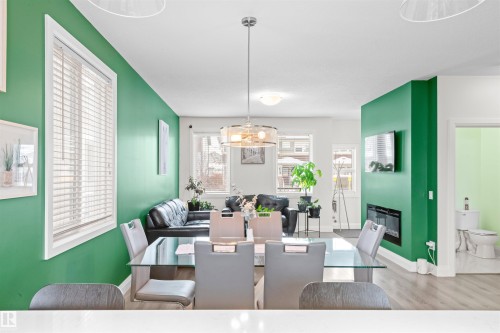 Open-concept living area featuring a prominent accent wall - 389 Charlesworth Drive, Edmonton, AB 