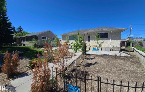 Contemporary exterior with light-colored stucco and a dark shingle roof - 12432 96 Street, Edmonton, AB 