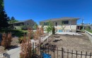 Contemporary exterior with light-colored stucco and a dark shingle roof - 12432 96 Street, Edmonton, AB 