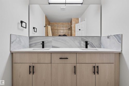 Dual vanity with light wood-finish cabinetry, white countertop, and integrated sinks - 7304/7306 78 Avenue, Edmonton, AB 
