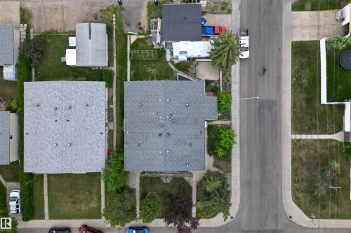 Overhead view of residential properties featuring shingle roofs, paved streets, and concrete sidewalks - 7304/7306 78 Avenue, Edmonton, AB 