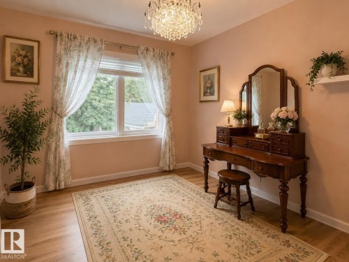 Wood-finish flooring with a decorative area rug, large window with sheer patterned curtains, and a crystal chandelier - 10912 50 Street, Edmonton, AB 