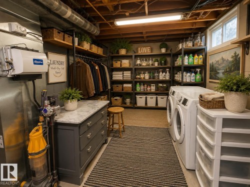 Dedicated laundry area featuring front-loading washer and dryer units - 10912 50 Street, Edmonton, AB 