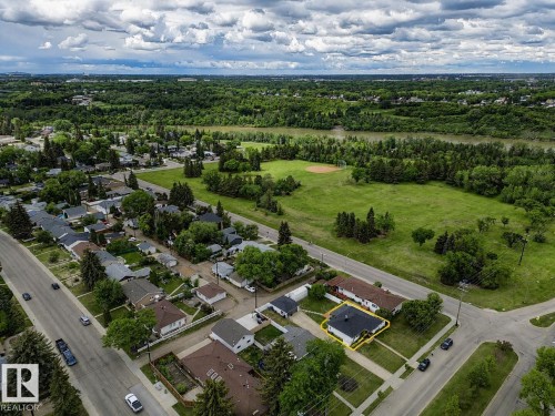 Aerial perspective showcasing a residential property with a dark shingle roof and light-colored siding - 10912 50 Street, Edmonton, AB 
