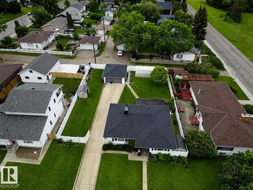 Aerial perspective showcasing a single-story residence with a dark shingle roof, accompanied by a detached garage - 10912 50 Street, Edmonton, AB 