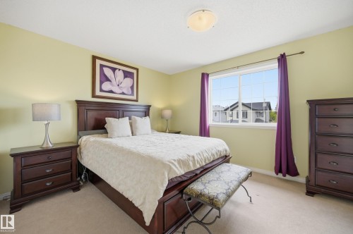 Carpeted room featuring a large window, a ceiling-mounted light fixture, and light-toned walls - 11628 167A Avenue, Edmonton, AB - Indoor Photo Showing Bedroom