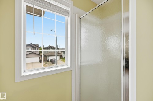 Window with white framing, integrated blinds, and grid-patterned panes - 11628 167A Avenue, Edmonton, AB - Indoor