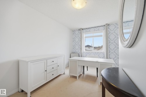 Room featuring textured wallpaper, a window with exterior views, and a flush mount ceiling light fixture - 11628 167A Avenue, Edmonton, AB - Indoor Photo Showing Other Room