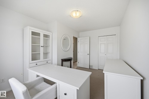 Neutral wall paint with carpet flooring, flush mount lighting, and a white interior door - 11628 167A Avenue, Edmonton, AB - Indoor Photo Showing Other Room