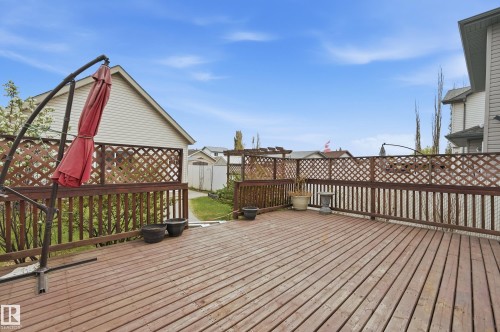 Expansive wood-finish deck featuring a full perimeter railing with lattice accents - 11628 167A Avenue, Edmonton, AB - Outdoor With Exterior