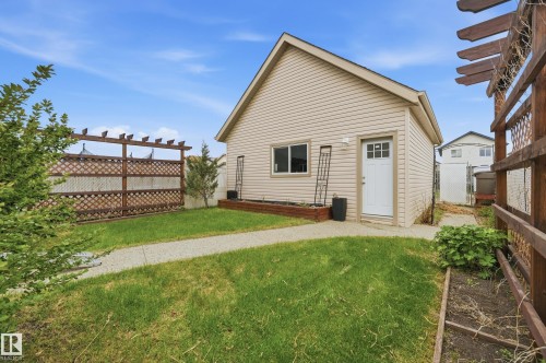 Detached accessory building with light-colored siding and a white entry door - 11628 167A Avenue, Edmonton, AB - Outdoor