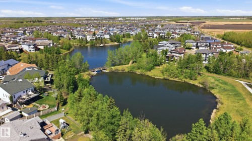 Aerial perspective showcasing a residential community with a central water feature - 11628 167A Avenue, Edmonton, AB - Outdoor With Body Of Water With View