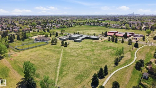 Expansive green space featuring recreational fields, mature trees, and a distant cityscape - 11628 167A Avenue, Edmonton, AB - Outdoor With View