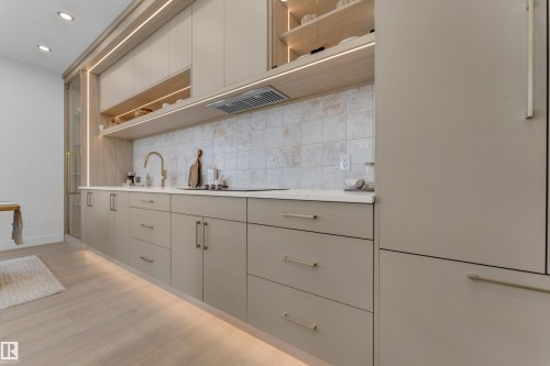 Kitchen featuring light wood-finish flooring and integrated under-cabinet lighting - 206 Linden Loop, Leduc, AB 