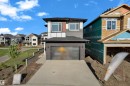 Contemporary two-story residence featuring a striking multi-textured facade with dark brick, gray siding, and white and brown accent panels - 206 Linden Loop, Leduc, AB 