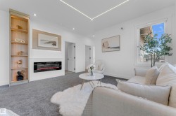 Living area featuring a built-in electric fireplace, recessed lighting, and integrated ceiling lighting - 