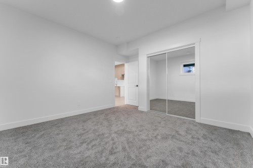 Spacious room featuring gray carpet flooring and white painted walls - 206 Linden Loop, Leduc, AB 