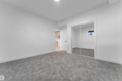 Spacious room featuring gray carpet flooring and white painted walls - 