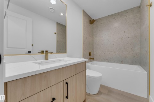 Bathroom featuring a light wood-finish vanity with a white countertop and integrated sink - 206 Linden Loop, Leduc, AB 