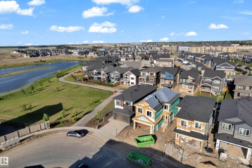 Residential development featuring a natural water body, paved walking paths, and a variety of modern architectural styles - 206 Linden Loop, Leduc, AB 