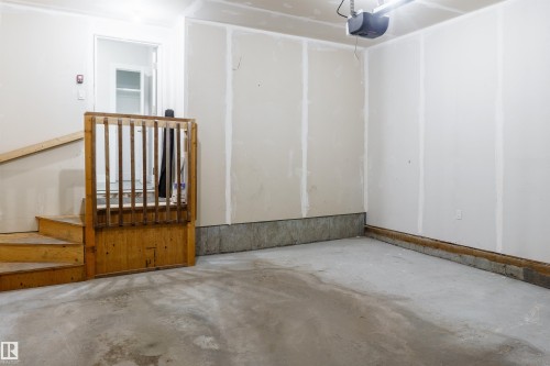 Spacious garage with concrete flooring and unfinished drywall walls - 2104 160 Street Sw, Edmonton, AB 