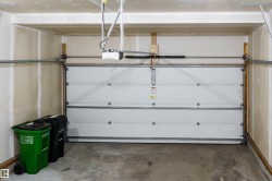Attached single-car garage featuring a sectional overhead door with an automatic opener - 