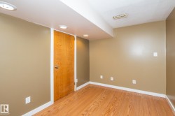 Room featuring wood-finish flooring, recessed lighting, and a neutral wall color - 