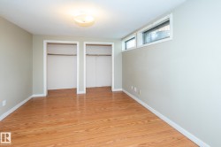 Room featuring wood-finish flooring and light-toned wall paint - 