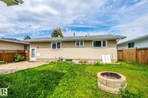Rear exterior of the property featuring a stucco finish and a shingled roof - 7543 149A Avenue, Edmonton, AB 