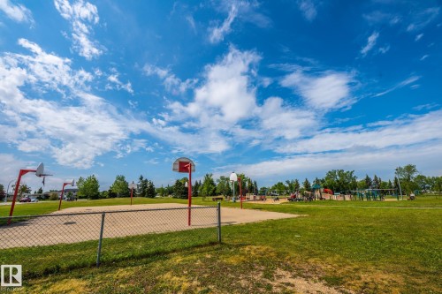 Outdoor sports court featuring multiple basketball hoops and a sand base - 7543 149A Avenue, Edmonton, AB 