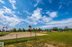 Outdoor sports court featuring multiple basketball hoops and a sand base - 