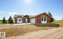 Red brick exterior with white trim and bay windows - 60230 Rg Rd 271, Rural Westlock County, AB 