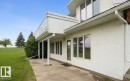 Exterior stucco finish with a ground-level concrete patio - 60230 Rg Rd 271, Rural Westlock County, AB 