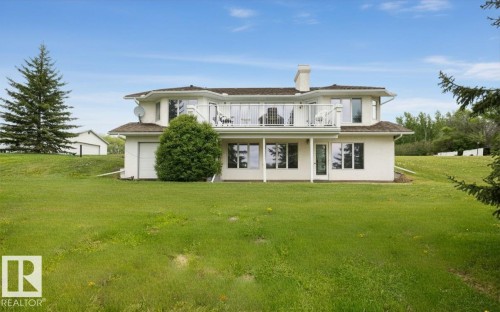 Two-story residence featuring a white stucco exterior and a brown shingle roof - 60230 Rg Rd 271, Rural Westlock County, AB 