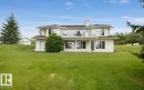 Two-story residence featuring a white stucco exterior and a brown shingle roof - 60230 Rg Rd 271, Rural Westlock County, AB 