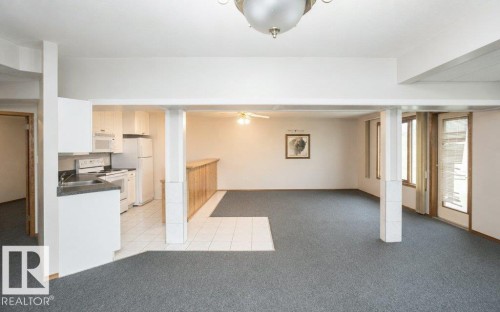 Lower-level living area featuring carpet flooring and white ceiling - 60230 Rg Rd 271, Rural Westlock County, AB 