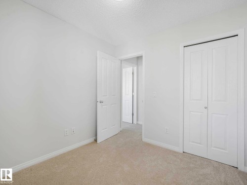 Neutral wall finishes and light-toned carpeting create a bright interior - 77 4050 Savaryn Drive, Edmonton, AB 