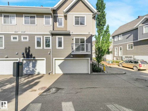 Contemporary townhome with multi-level siding and a private balcony - 77 4050 Savaryn Drive, Edmonton, AB 