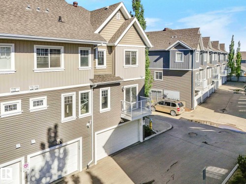 Townhome exterior featuring horizontal siding and shaker shingles - 77 4050 Savaryn Drive, Edmonton, AB 