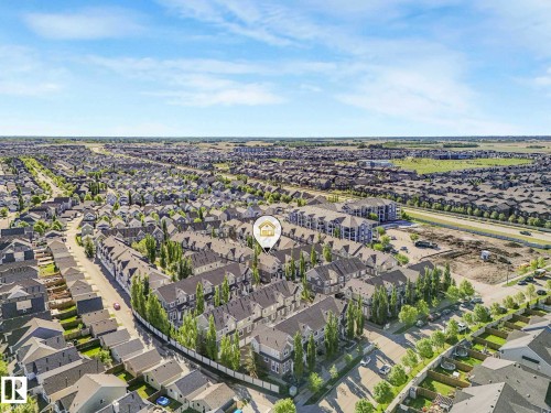 Expansive aerial view showcasing a developed residential neighborhood with a variety of housing styles and street layouts - 77 4050 Savaryn Drive, Edmonton, AB 
